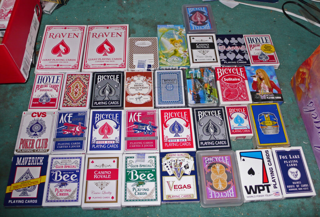 Various playing cards laid out on a table in neat rows and lines